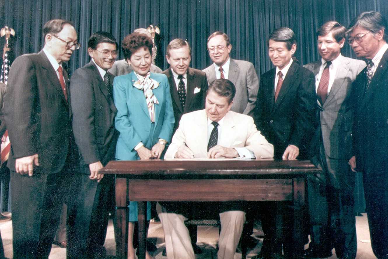 President Ronald Reagan signing the Civil Liberties Act