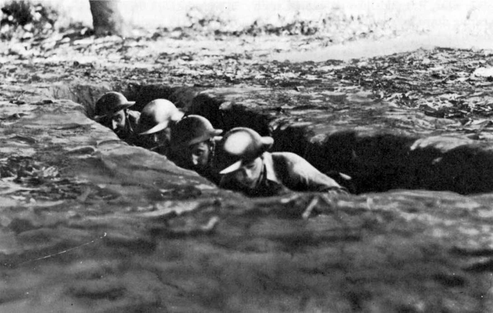 Soldiers hiding in a trench