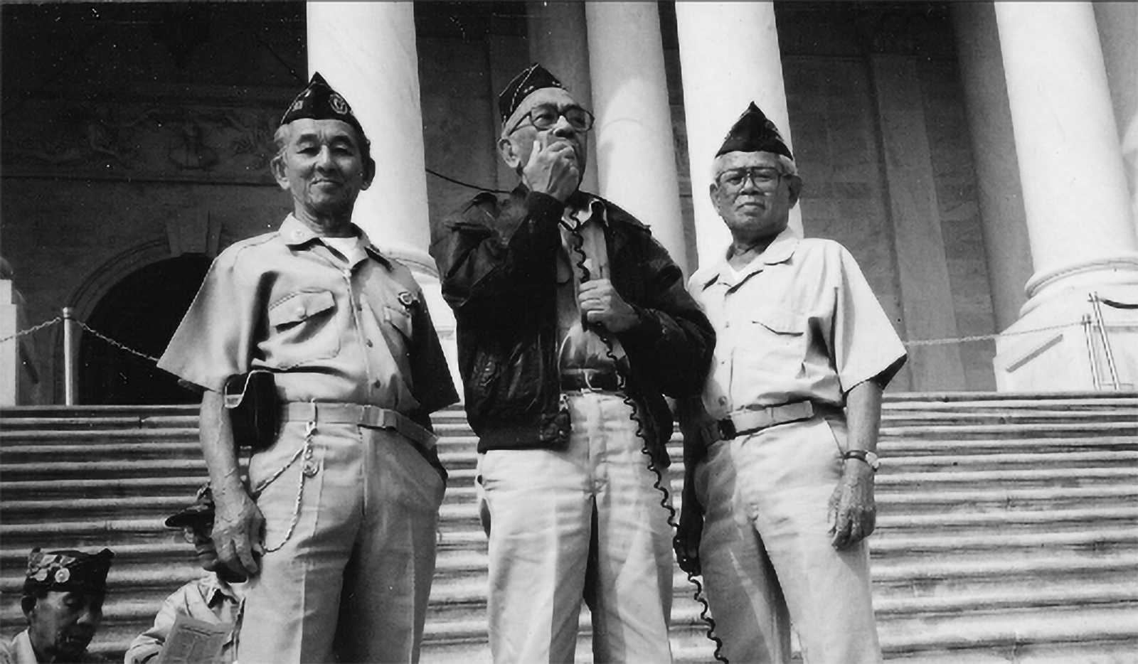 Filipinos make themselves heard on the steps of a government building.