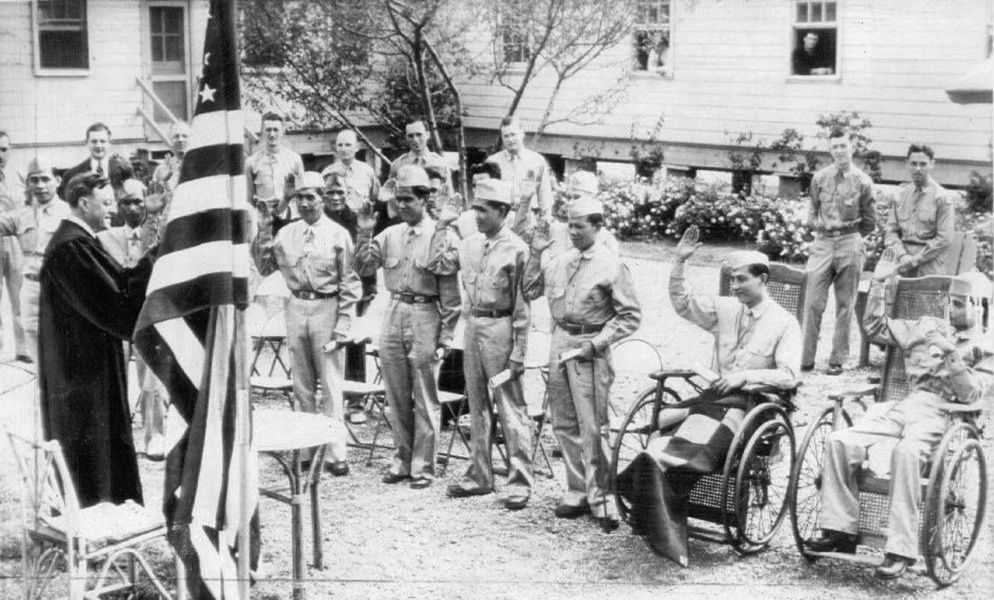 Photo of judge under the American flag overlooking Philippine Scouts