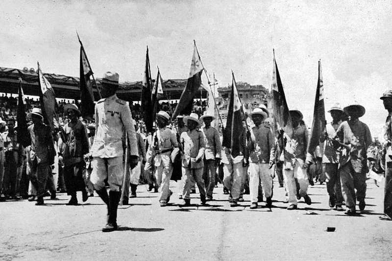 Photo of veterans marching with Philippine flags